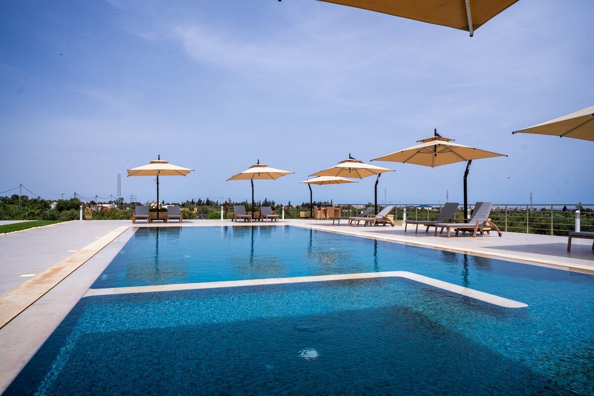 Piscine à débordement de la villa Dar Aïcha avec transats et vue dégagée